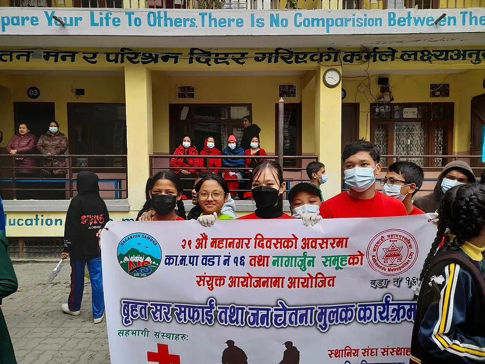 Students with the banner of the Metropolitan Day clean-up in Kathmandu ward 16